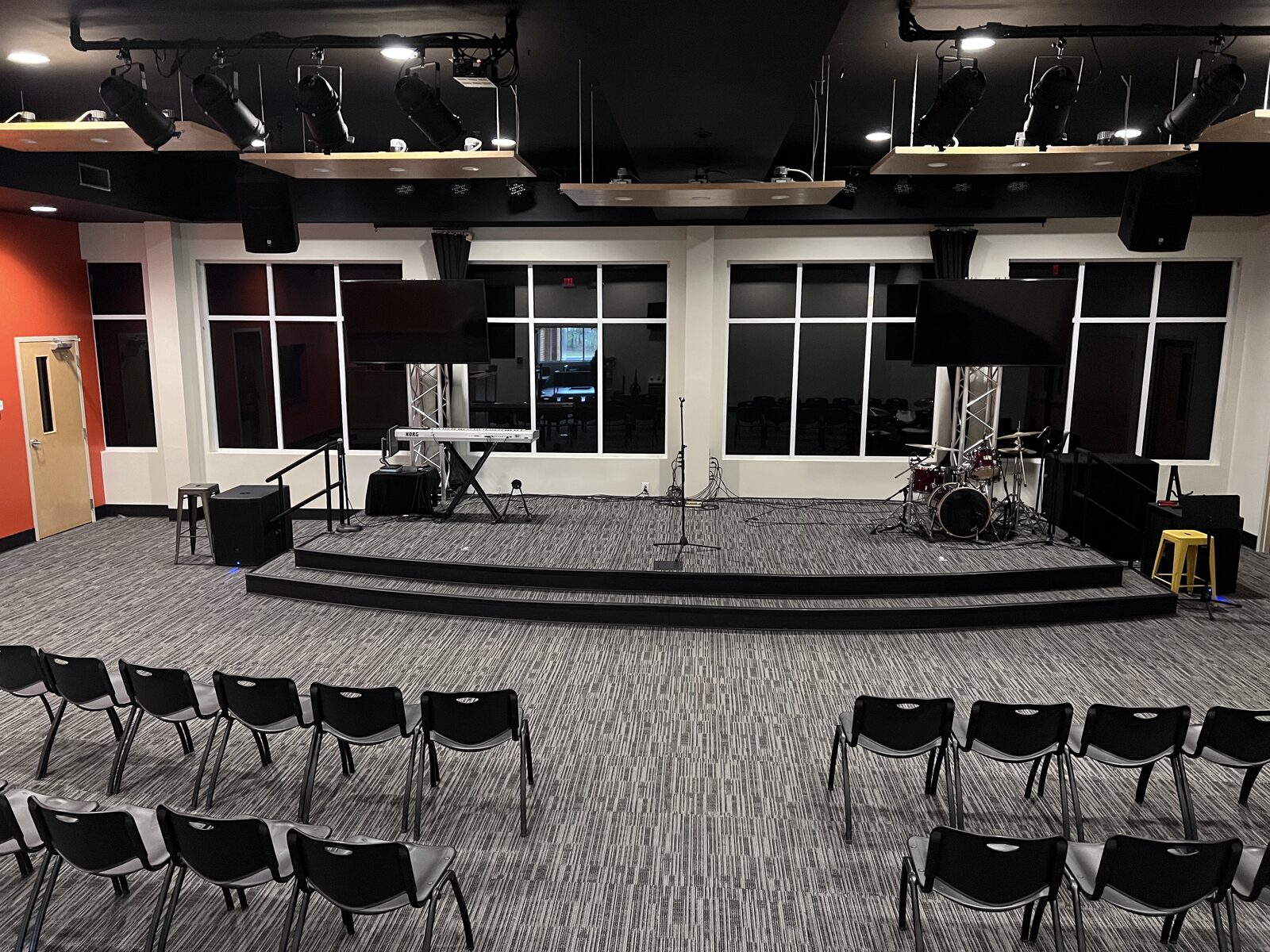 Tinted glass wall behind the stage in the NorthStar Church worship hall