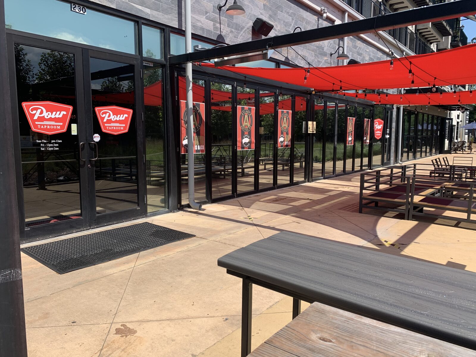 Reflective tinted storefront glass at Pour Taproom on the Atlanta BeltLine