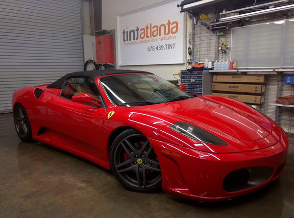 Red Ferrari F430 Spider convertible with premium window film at Tint Atlanta shop