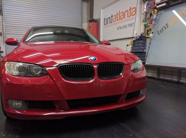 Red BMW Coupe front view with dark window tint by Tint Atlanta
