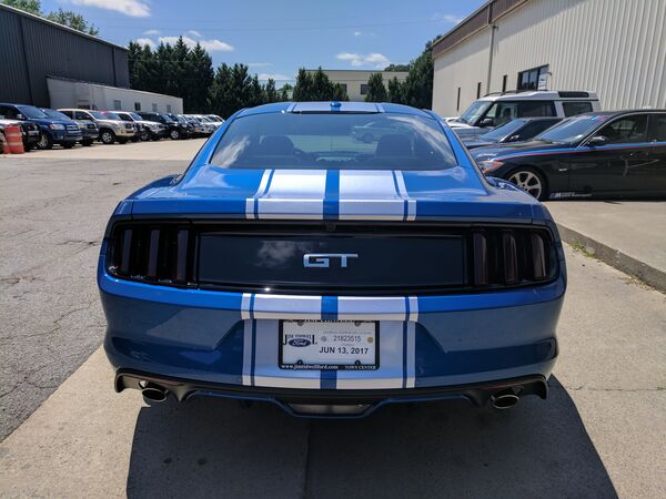 Blue Ford Mustang GT with racing stripes and tinted windows Atlanta